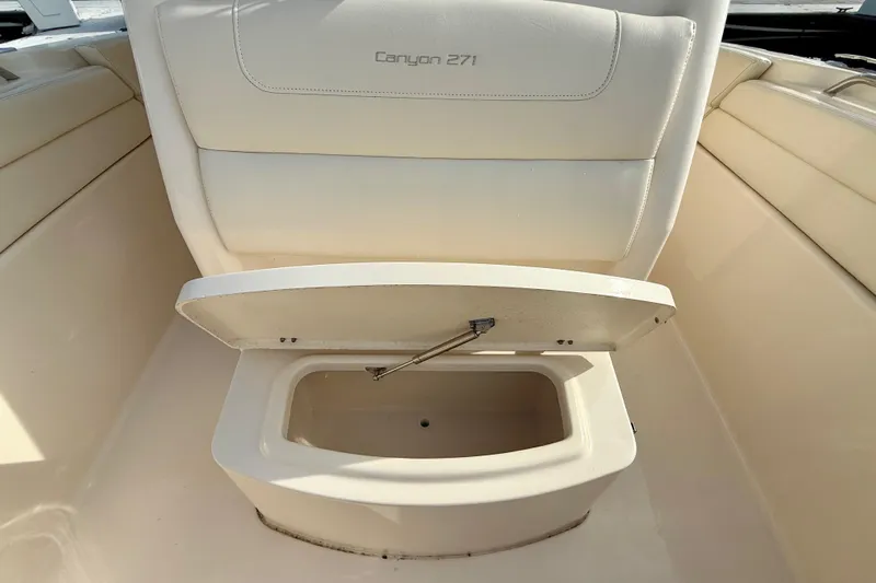 Neverland II Yacht Photos Pics 2022 Grady-White Canyon 271 boat seat with storage compartment open.