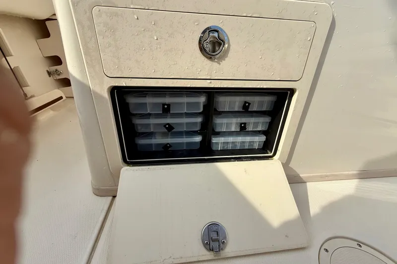 Neverland II Yacht Photos Pics Storage compartment with tackle boxes on a 2022 Grady-White Canyon 271 boat.