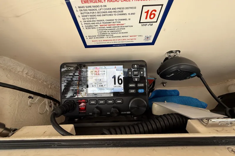 Neverland II Yacht Photos Pics VHF radio setup on 2022 Grady-White Canyon 271 boat, displaying emergency call instructions.