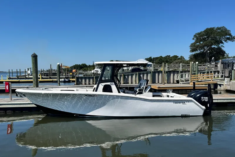  Yacht Photos Pics 2022 Tidewater 280 CC Adventure boat docked at marina under clear blue sky.