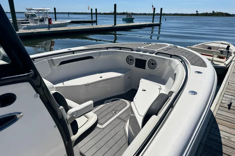  Yacht Photos Pics 2022 Tidewater 280 CC Adventure boat docked, featuring spacious seating and modern design.