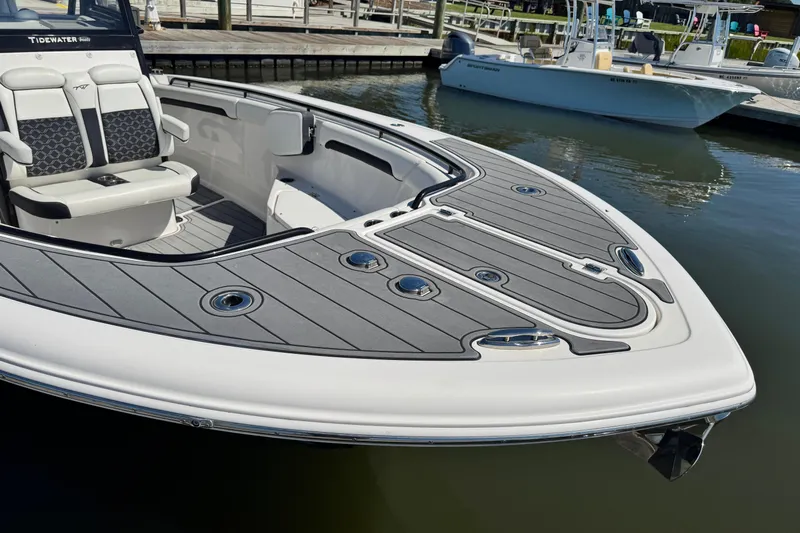  Yacht Photos Pics 2022 Tidewater 280 CC Adventure boat with sleek deck design at marina.