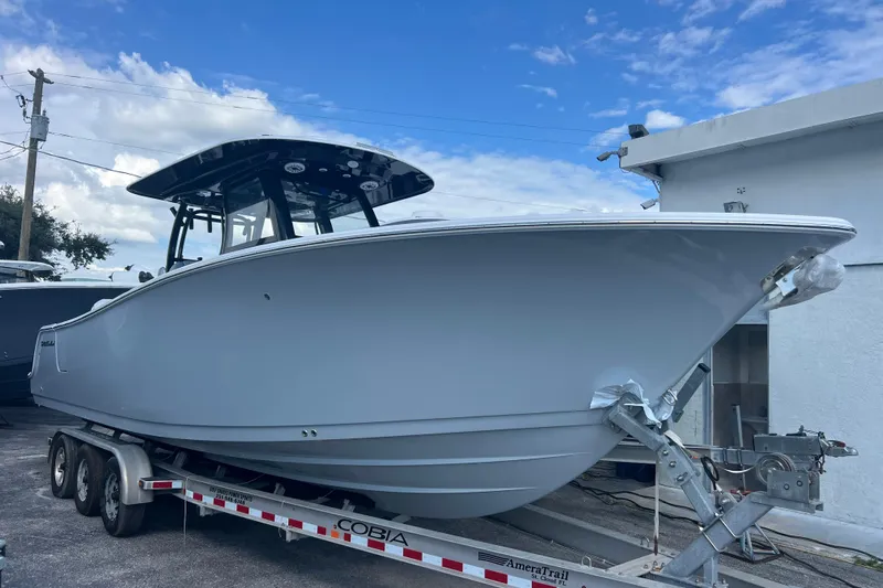  Yacht Photos Pics 2026 Sportsman Open 302 Center Console boat on trailer under blue sky.