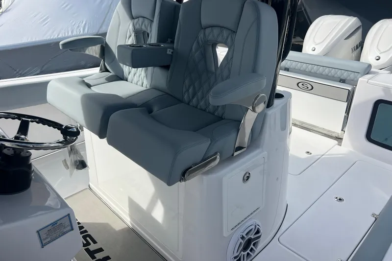  Yacht Photos Pics 2026 Sportsman Open 302 Center Console with luxurious seating and modern steering wheel.