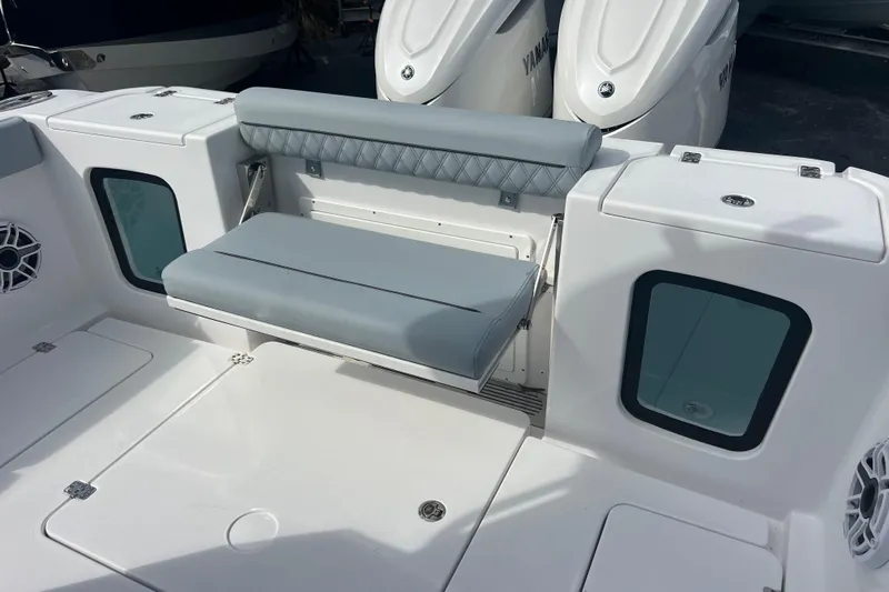  Yacht Photos Pics 2026 Sportsman Open 302 Center Console boat seating area with cushioned bench and storage compartments.