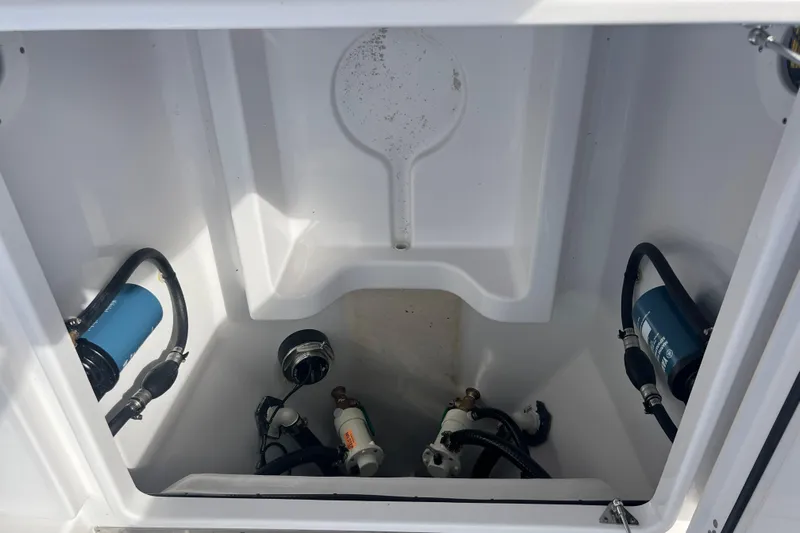  Yacht Photos Pics 2026 Sportsman Open 302 Center Console boat compartment with hoses and filters.