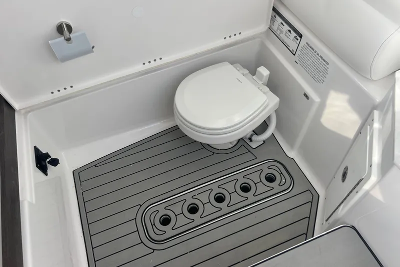  Yacht Photos Pics 2026 Sportsman Open 302 Center Console boat interior with modern marine toilet.