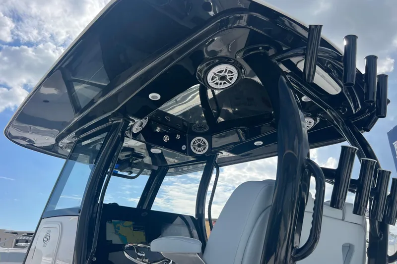  Yacht Photos Pics 2026 Sportsman Open 302 Center Console boat with sleek black T-top and modern features.