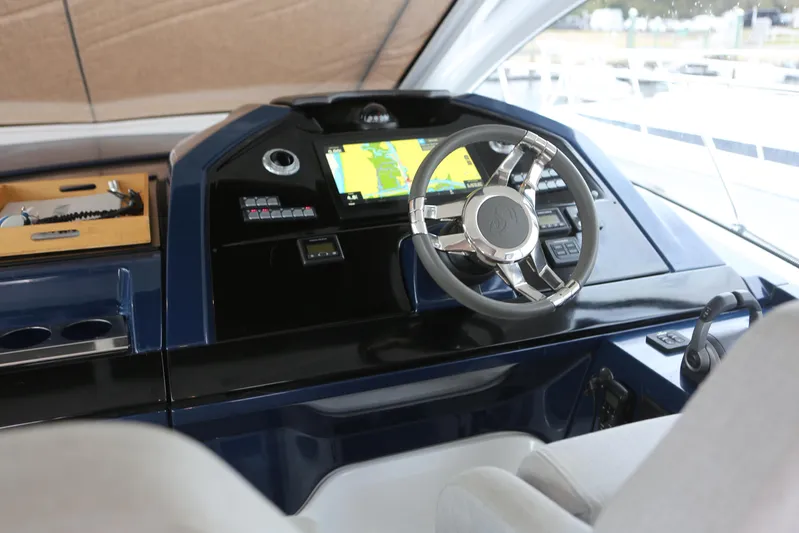 Lucky Lovers Yacht Photos Pics 2023 Beneteau Gran Turismo 45 helm with modern navigation system and sleek steering wheel.