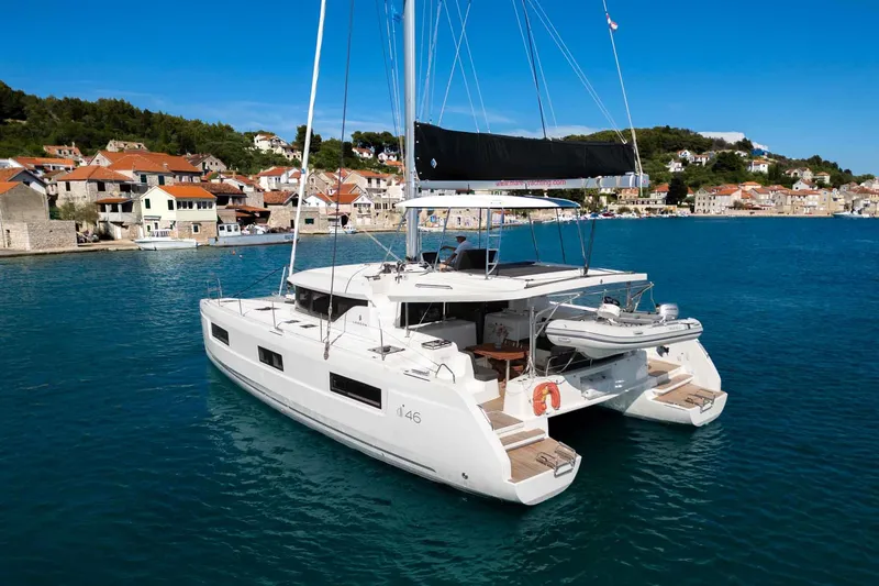 Mare Azul Yacht Photos Pics 2024 Lagoon 46 catamaran docked in a scenic coastal village.