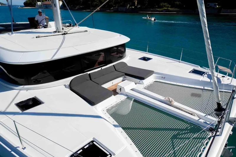 Mare Azul Yacht Photos Pics 2024 Lagoon 46 catamaran with spacious deck and netting over turquoise water.