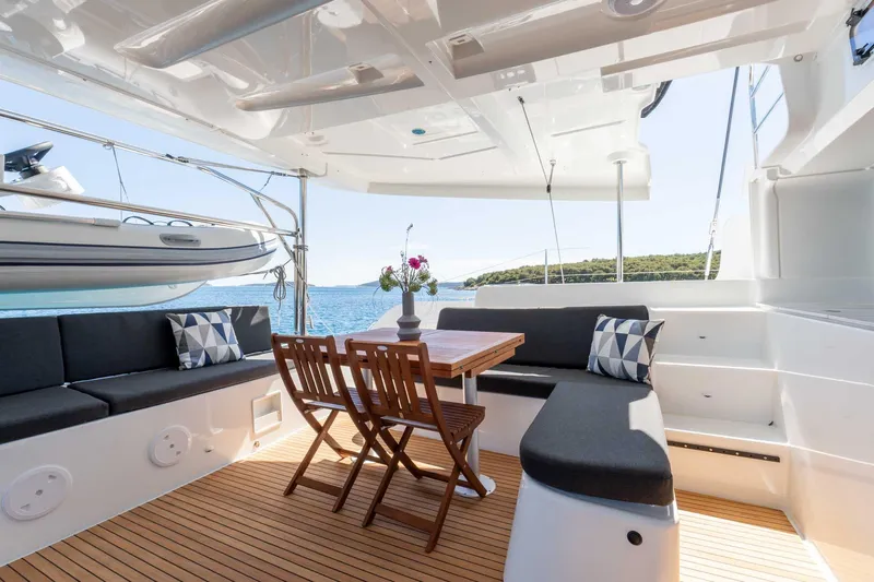 Mare Azul Yacht Photos Pics 2024 Lagoon 46 yacht interior with seating, table, and ocean view.