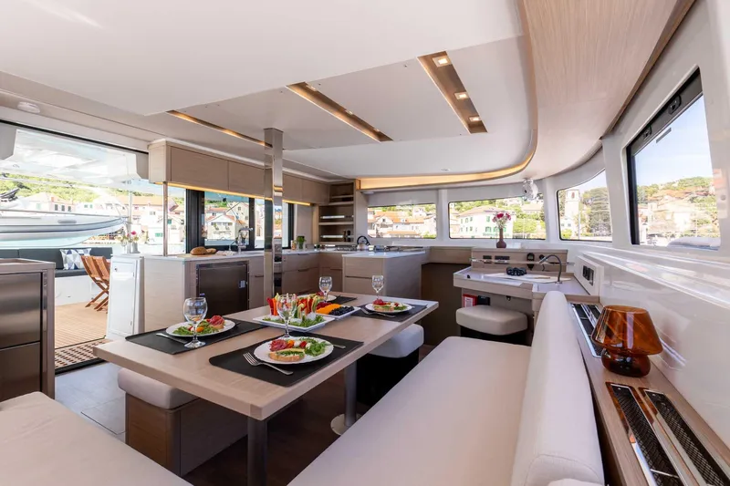 Mare Azul Yacht Photos Pics Luxurious interior of 2024 Lagoon 46 yacht with elegant dining setup.