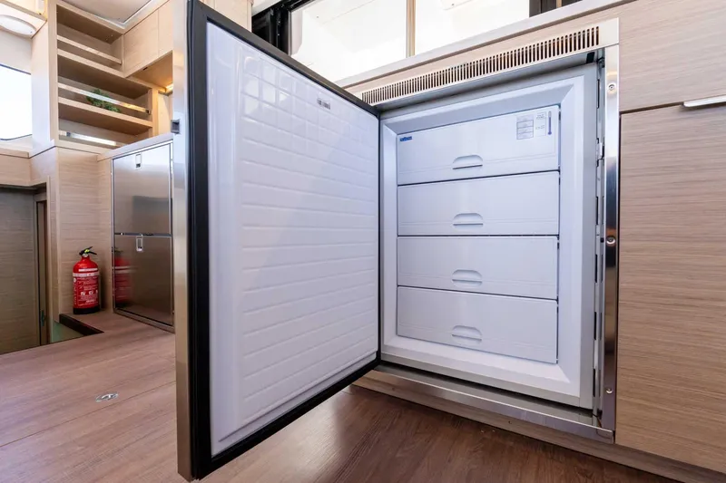 Mare Azul Yacht Photos Pics Open freezer with drawers inside a 2024 Lagoon 46 yacht kitchen.