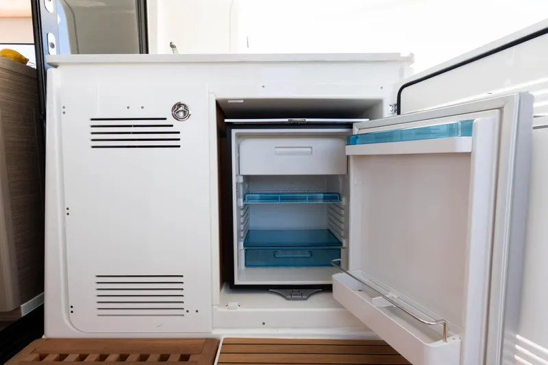 Mare Azul Yacht Photos Pics 2024 Lagoon 46 yacht interior with open mini fridge, showcasing modern design.
