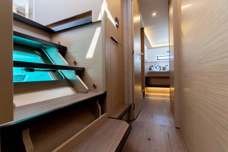Mare Azul Yacht Photos Pics 2024 Lagoon 46 yacht interior with modern wooden stairs and hallway.