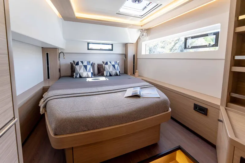 Mare Azul Yacht Photos Pics Luxurious cabin interior of 2024 Lagoon 46 yacht with modern design and cozy bedding.