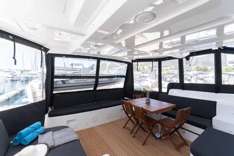 Mare Azul Yacht Photos Pics Interior of 2024 Lagoon 46 yacht with seating and dining area.