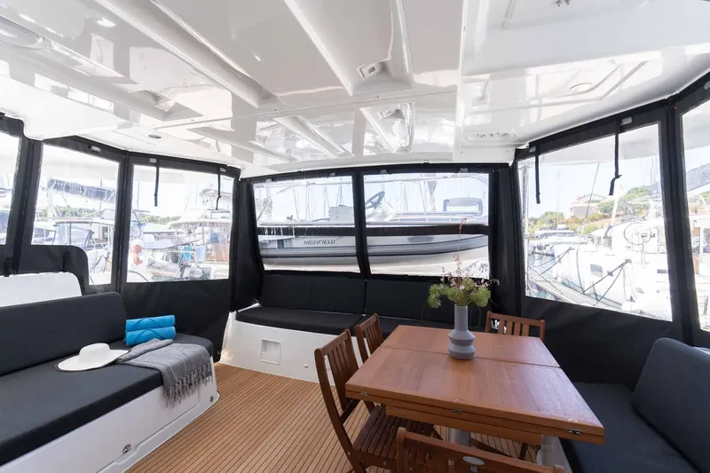 Mare Azul Yacht Photos Pics Spacious interior of 2024 Lagoon 46 yacht with seating and dining area.