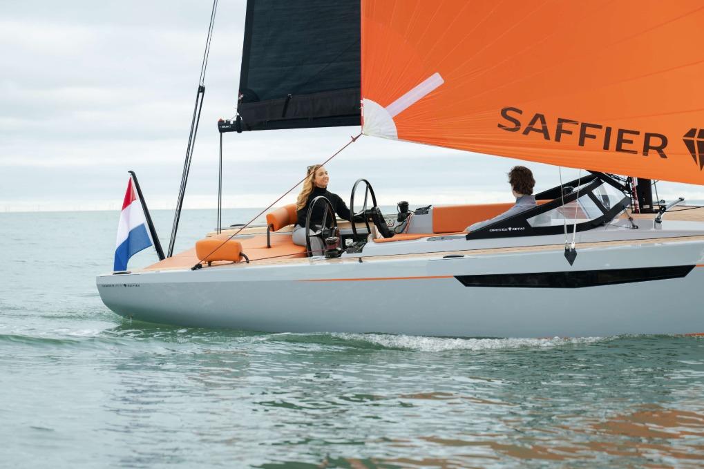 2026 Saffier SE 28 Leopard sailing with orange sail on calm waters.
