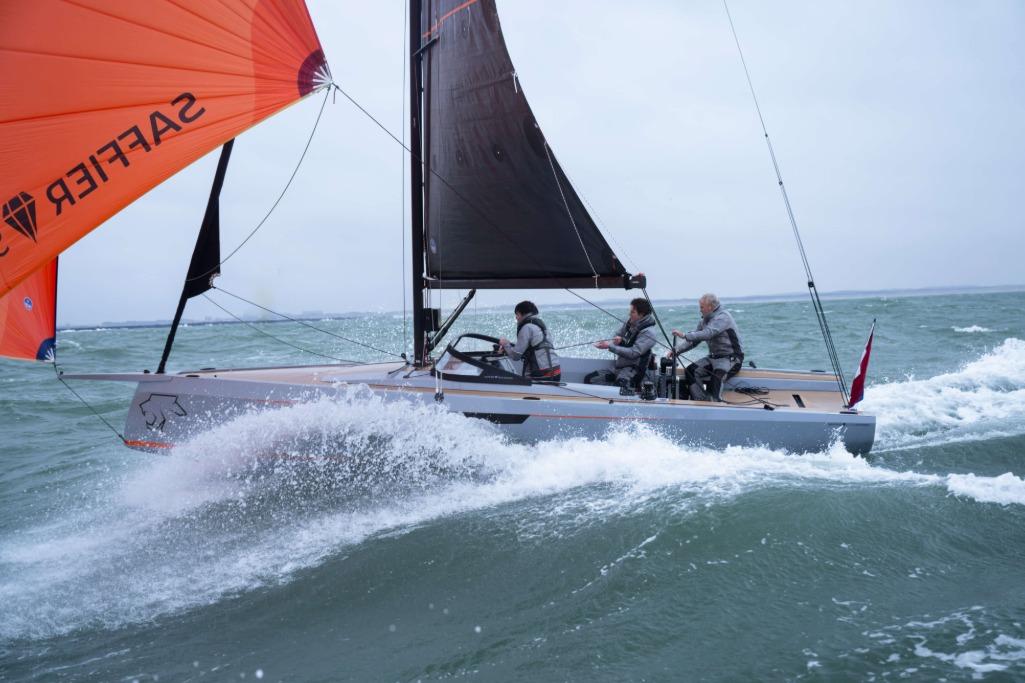 2026 Saffier SE 28 Leopard sailing in rough seas with orange sail.