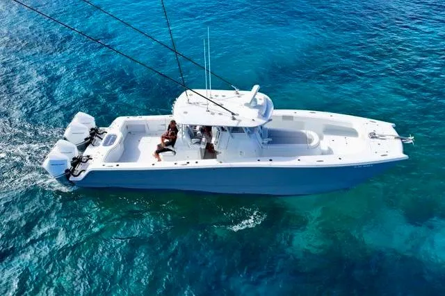  Yacht Photos Pics Aerial view of 2022 Freeman 37 VH boat cruising in clear blue ocean waters.