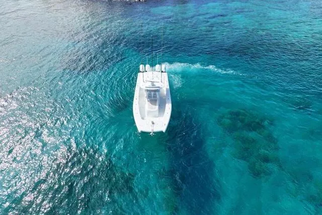  Yacht Photos Pics Aerial view of 2022 Freeman 37 VH boat cruising in clear blue ocean waters.