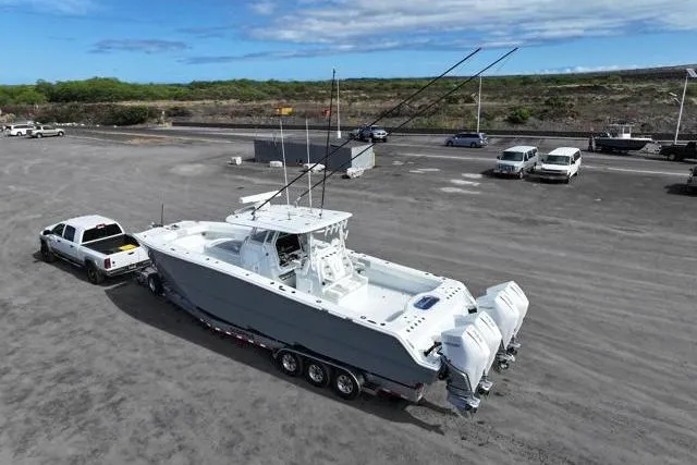  Yacht Photos Pics 2022 Freeman 37 VH boat on trailer, towed by a truck in a parking lot.