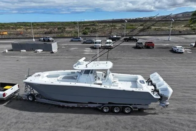  Yacht Photos Pics 2022 Freeman 37 VH boat on trailer, parked in a lot with vehicles nearby.