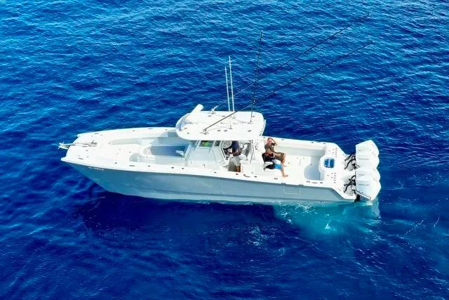  Yacht Photos Pics Aerial view of 2022 Freeman 37 VH boat cruising on clear blue ocean waters.