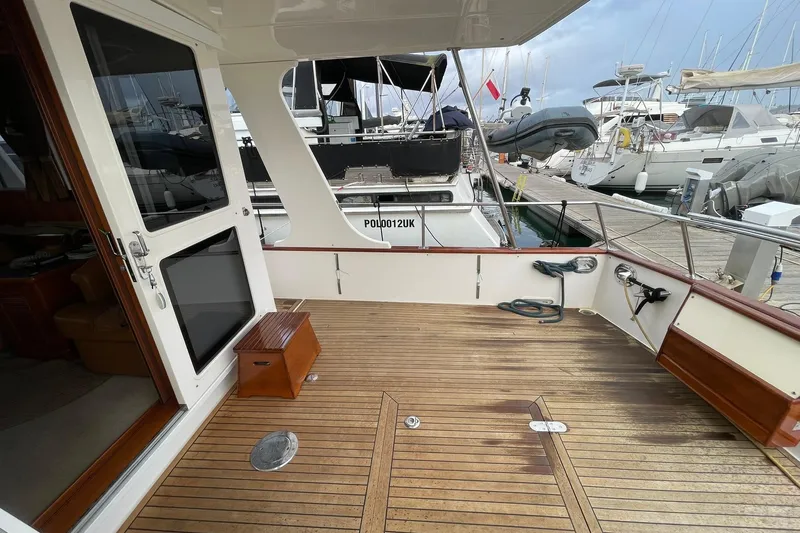 Peponi II Yacht Photos Pics 2008 Grand Banks 47 Heritage EU yacht deck with wooden flooring, docked at marina.