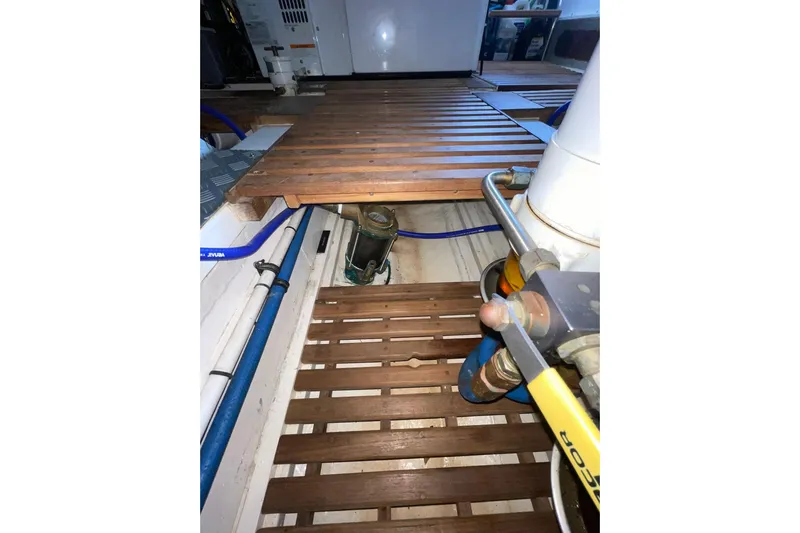 Peponi II Yacht Photos Pics Engine room of 2008 Grand Banks 47 Heritage EU with wooden flooring and visible pipes.