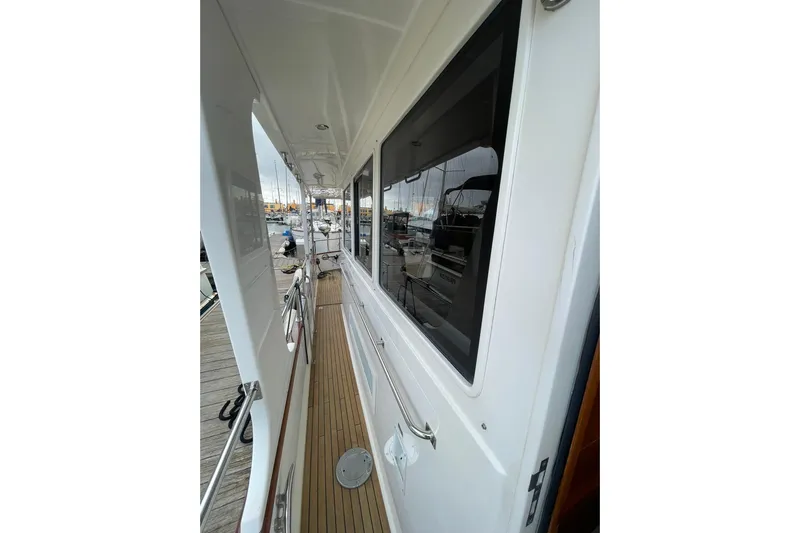 Peponi II Yacht Photos Pics Side deck view of 2008 Grand Banks 47 Heritage EU yacht, featuring teak flooring and white exterior.