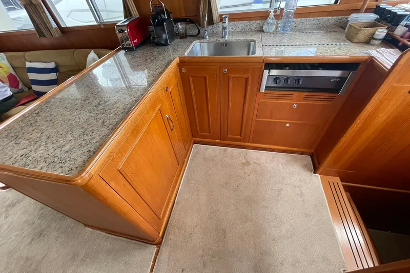 Peponi II Yacht Photos Pics 2008 Grand Banks 47 Heritage EU yacht kitchen with wood cabinetry and granite countertops.