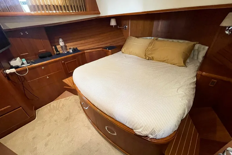 Peponi II Yacht Photos Pics Luxurious cabin interior of 2008 Grand Banks 47 Heritage EU yacht with cozy bed and wooden finish.