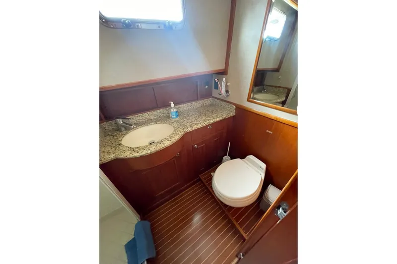 Peponi II Yacht Photos Pics Luxurious 2008 Grand Banks 47 Heritage EU yacht bathroom with granite countertop and wooden accents.