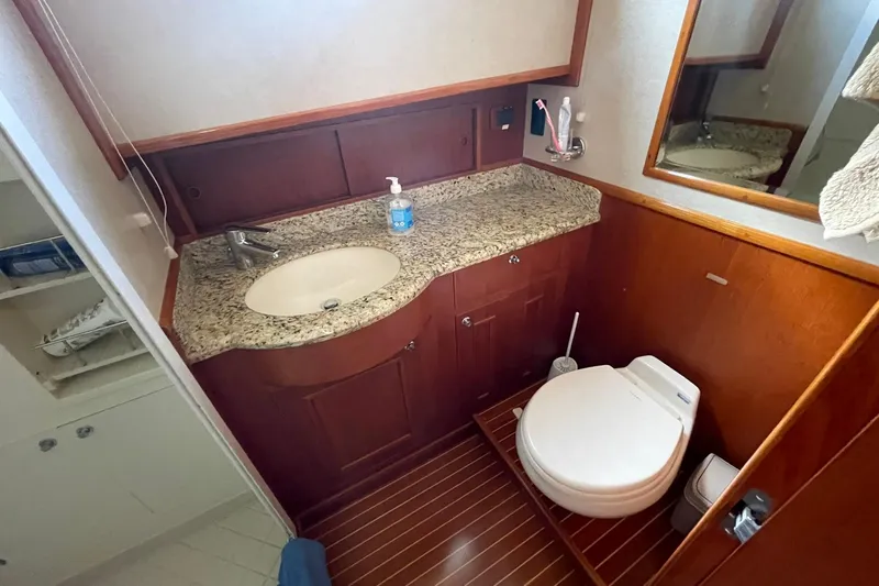 Peponi II Yacht Photos Pics Luxurious 2008 Grand Banks 47 Heritage EU yacht bathroom with granite countertop and wooden cabinetry.