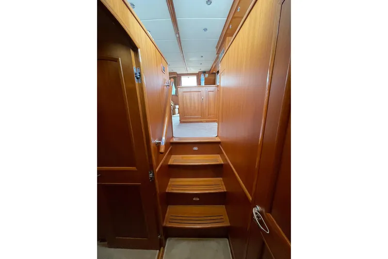 Peponi II Yacht Photos Pics Interior stairs of 2008 Grand Banks 47 Heritage EU yacht, featuring elegant wood paneling.