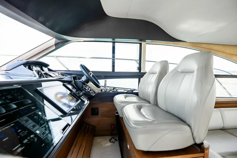 Zefa Yacht Photos Pics Interior of 2019 Princess 43 Flybridge yacht with modern helm and leather seating.