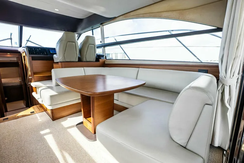 Zefa Yacht Photos Pics Luxurious interior of 2019 Princess 43 Flybridge yacht with elegant seating and table.