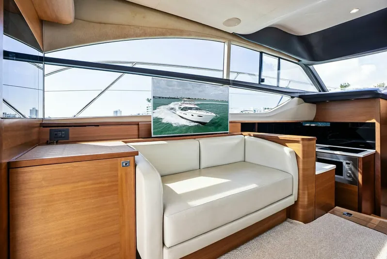 Zefa Yacht Photos Pics Luxurious interior of 2019 Princess 43 Flybridge yacht with modern seating and panoramic windows.