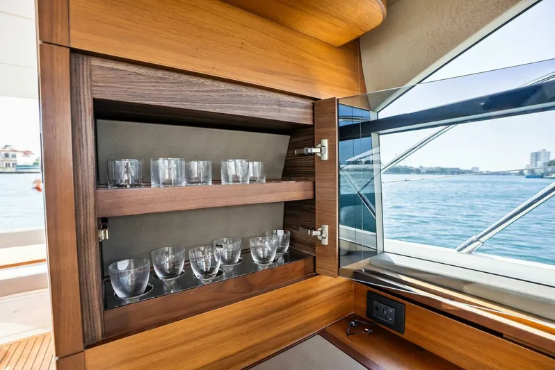 Zefa Yacht Photos Pics Luxurious interior of 2019 Princess 43 Flybridge yacht with glassware cabinet.