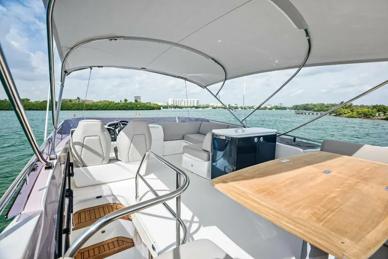 Zefa Yacht Photos Pics Flybridge view of 2019 Princess 43 yacht with seating and table, on calm waters.