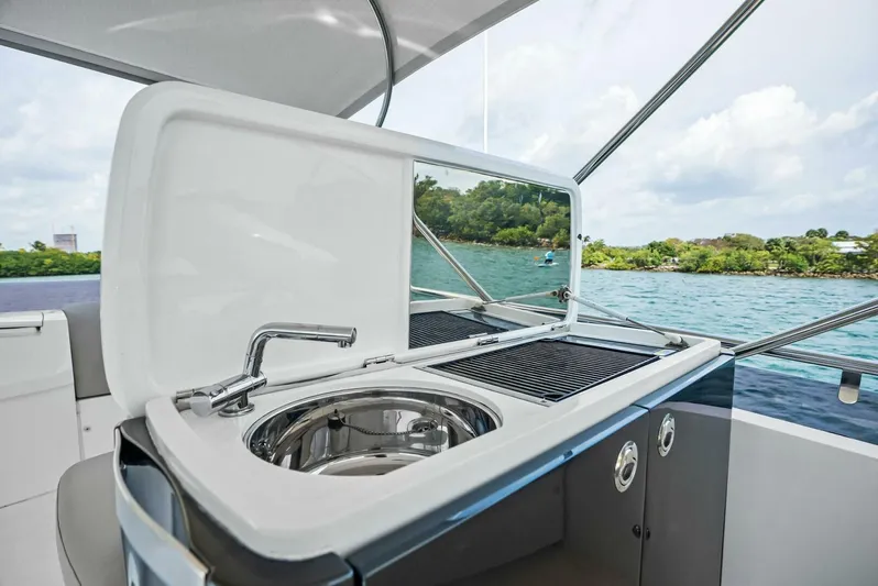 Zefa Yacht Photos Pics 2019 Princess 43 Flybridge yacht with outdoor sink and grill, overlooking scenic water view.