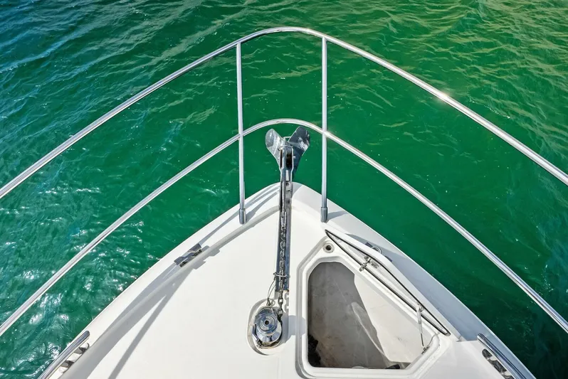 Zefa Yacht Photos Pics Bow view of 2019 Princess 43 Flybridge yacht on clear green water.