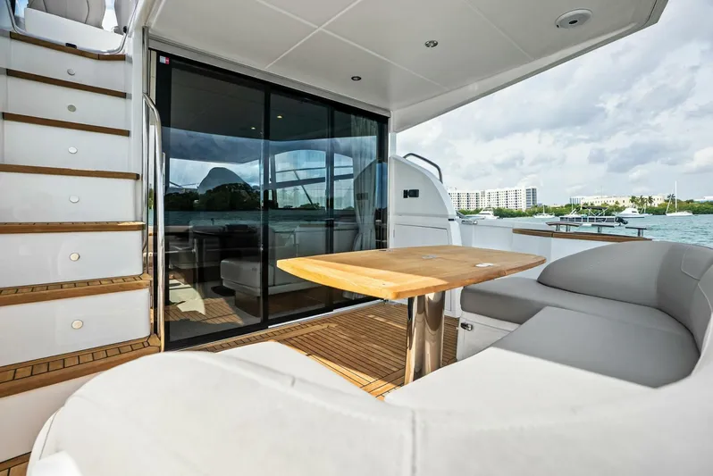 Zefa Yacht Photos Pics 2019 Princess 43 Flybridge yacht with outdoor seating and wooden table.