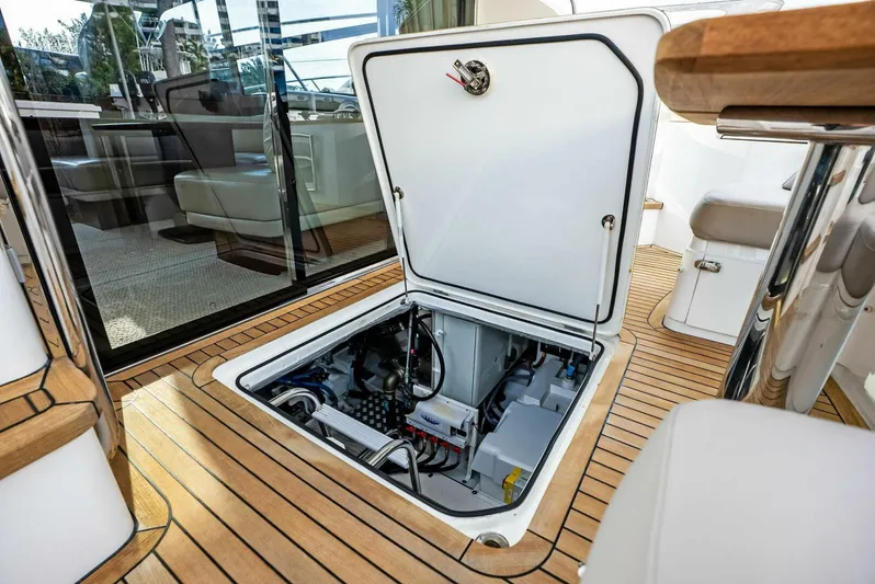 Zefa Yacht Photos Pics Engine compartment of 2019 Princess 43 Flybridge yacht with open hatch on teak deck.