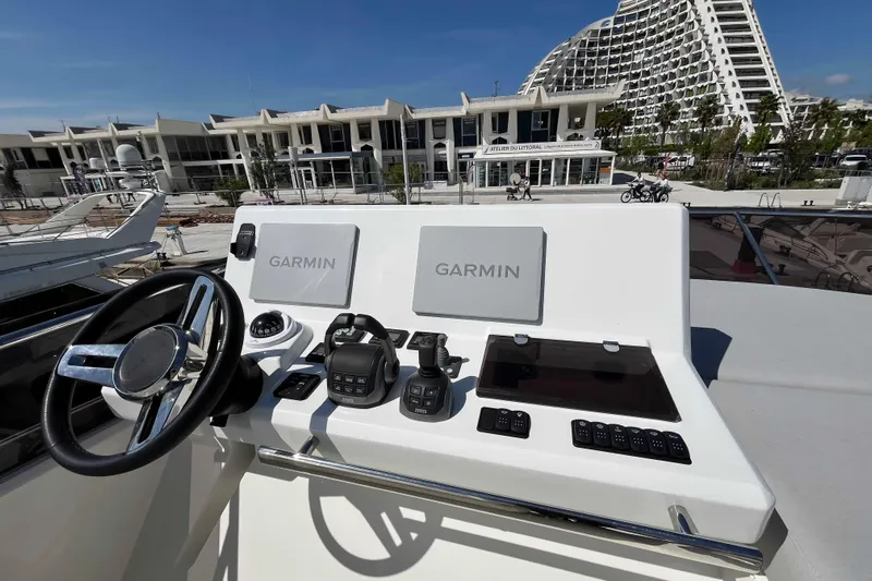  Yacht Photos Pics 2023 Prestige 520 yacht helm with Garmin navigation, modern controls, and waterfront view.