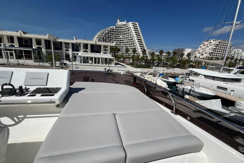  Yacht Photos Pics 2023 Prestige 520 yacht with Garmin controls, docked in a modern marina.