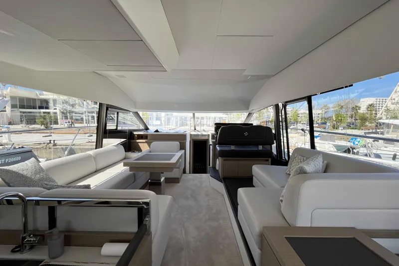  Yacht Photos Pics Luxurious interior of 2023 Prestige 520 yacht with modern seating and panoramic windows.